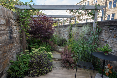 tiny Edinburgh courtyard garden design with plant covered pergolas