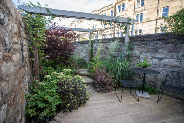 view form the patio doors showing the patio and plant covered pergola posts